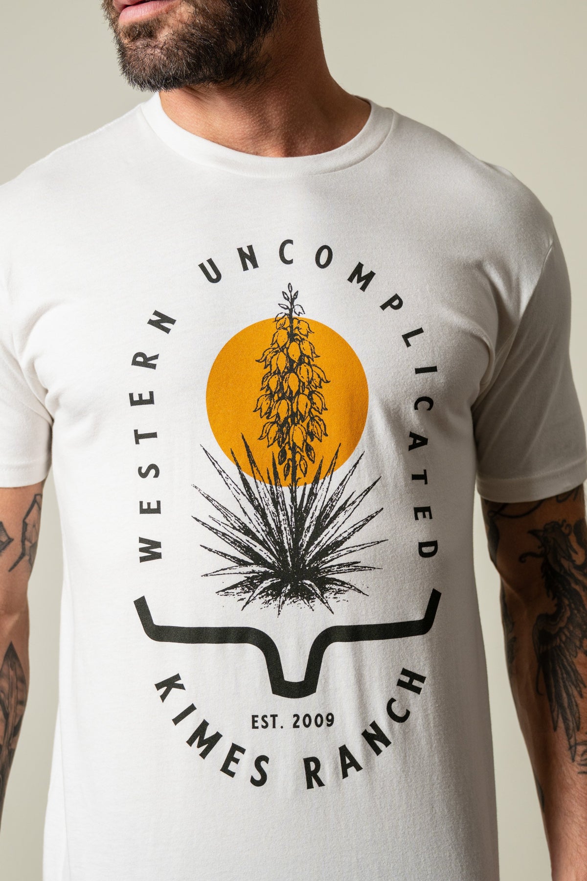 Kimes Ranch Drought Resistant bone t-shirt with graphic of a yucca in a yellow circle above the Kimes Ranch logo; #color_bone