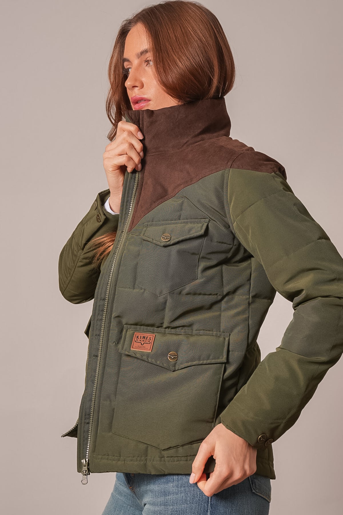 Kimes Ranch Lenora jacket in Dark Olive, featuring brown suede yoke, flap pockets, and Kimes Ranch logo patch