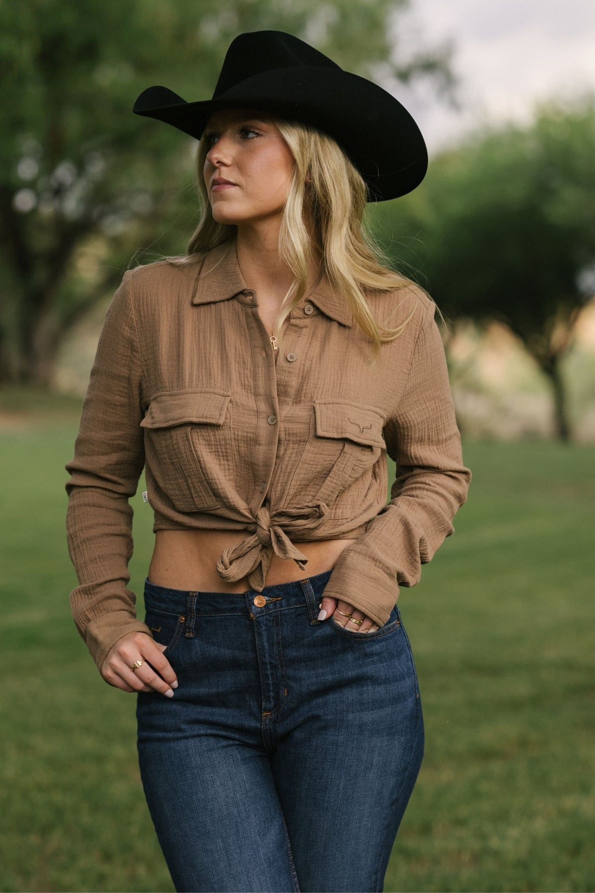 Kimes Ranch Torrean Tie Up top in taupe, a long sleeve button-down with a collar, two chest pockets, and a front tie detail