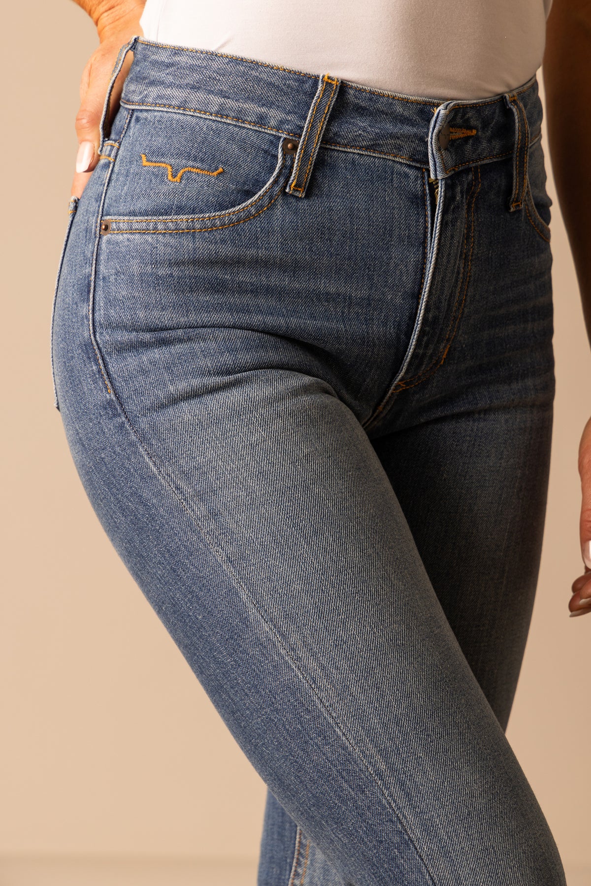 Kimes Ranch Jennifer Dark Wash mid wash jeans with back pocket stitching and orange contrast stitching; #color_mid wash