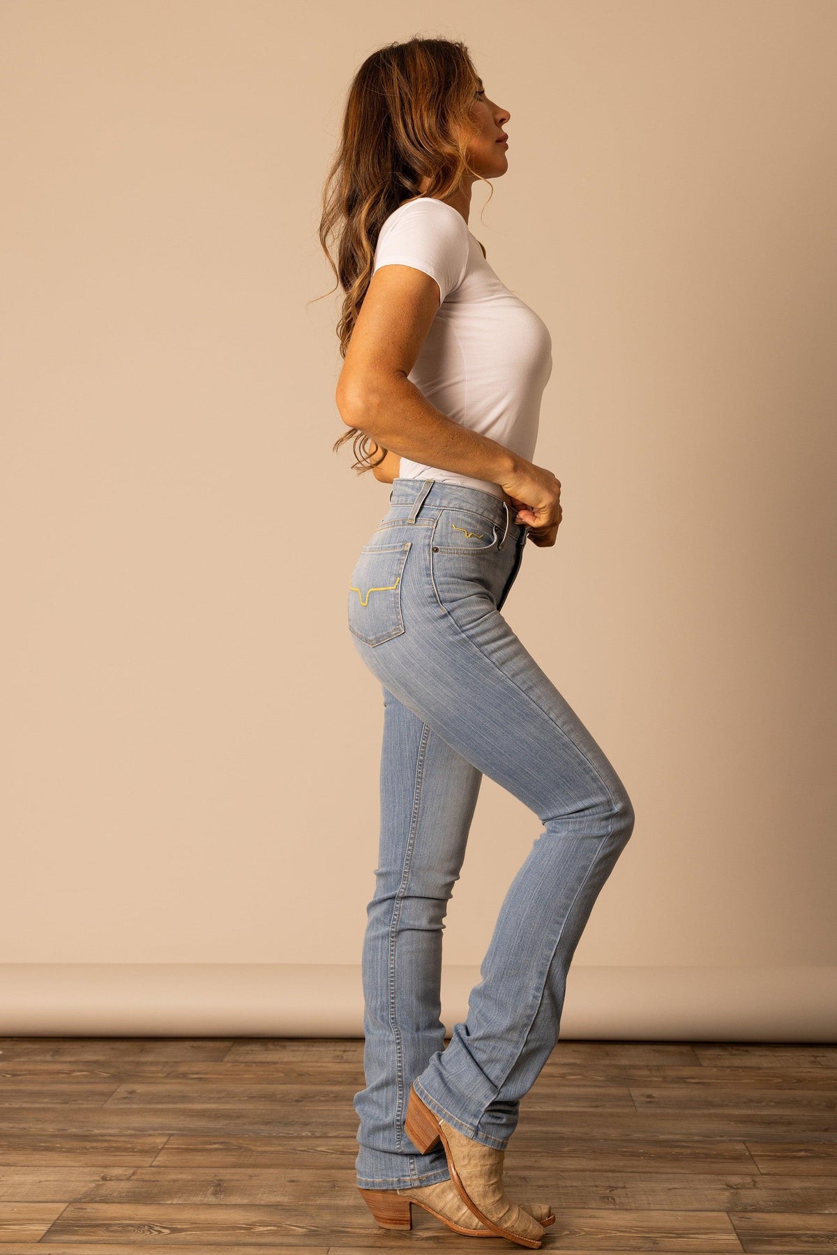 Kimes Ranch Sarah light wash jeans with yellow stitching and Kimes Ranch logo on back pockets; #color_light wash