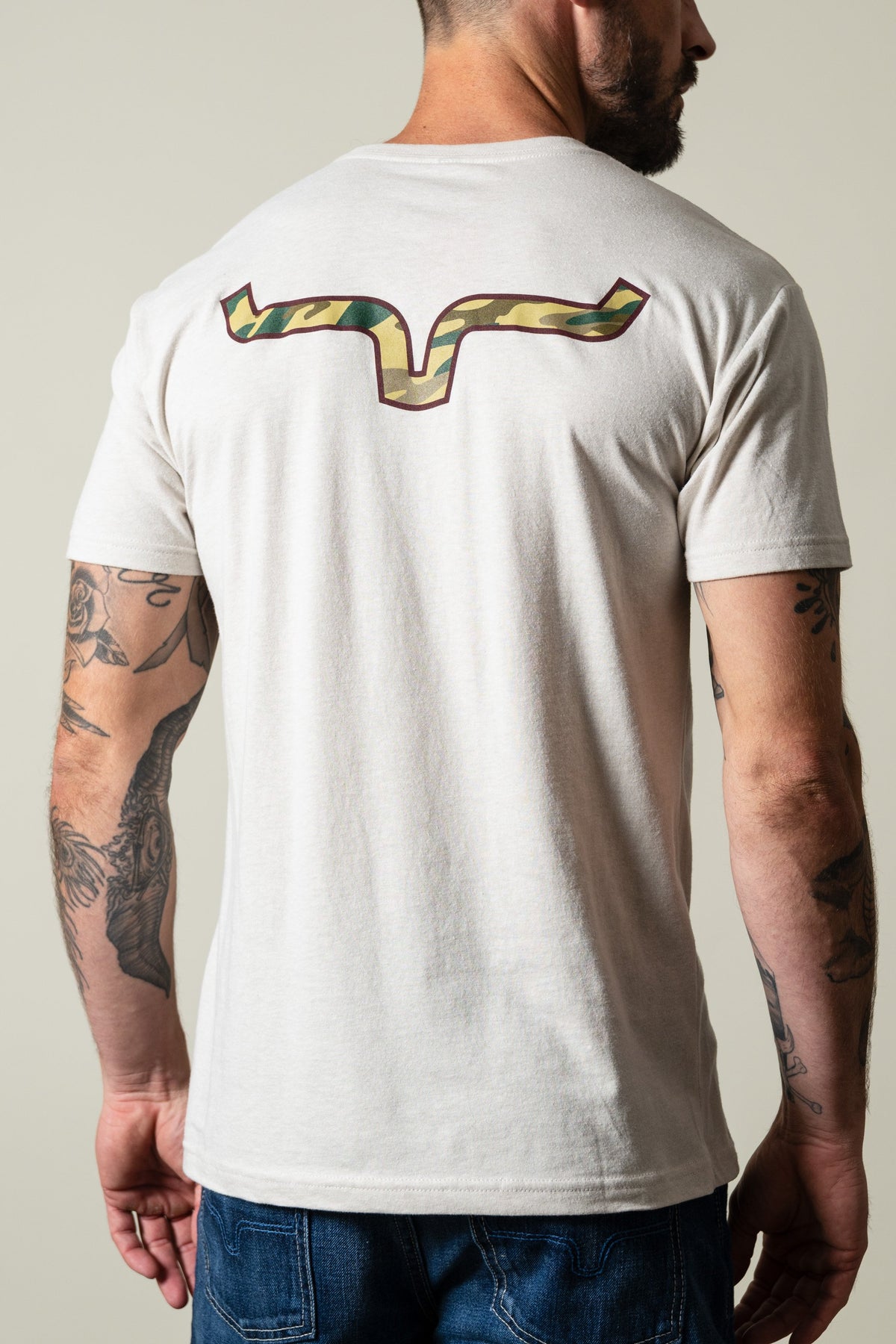 Kimes Ranch Camo Back t-shirt in sand, featuring the Kimes Ranch logo across the upper back; #color_sand