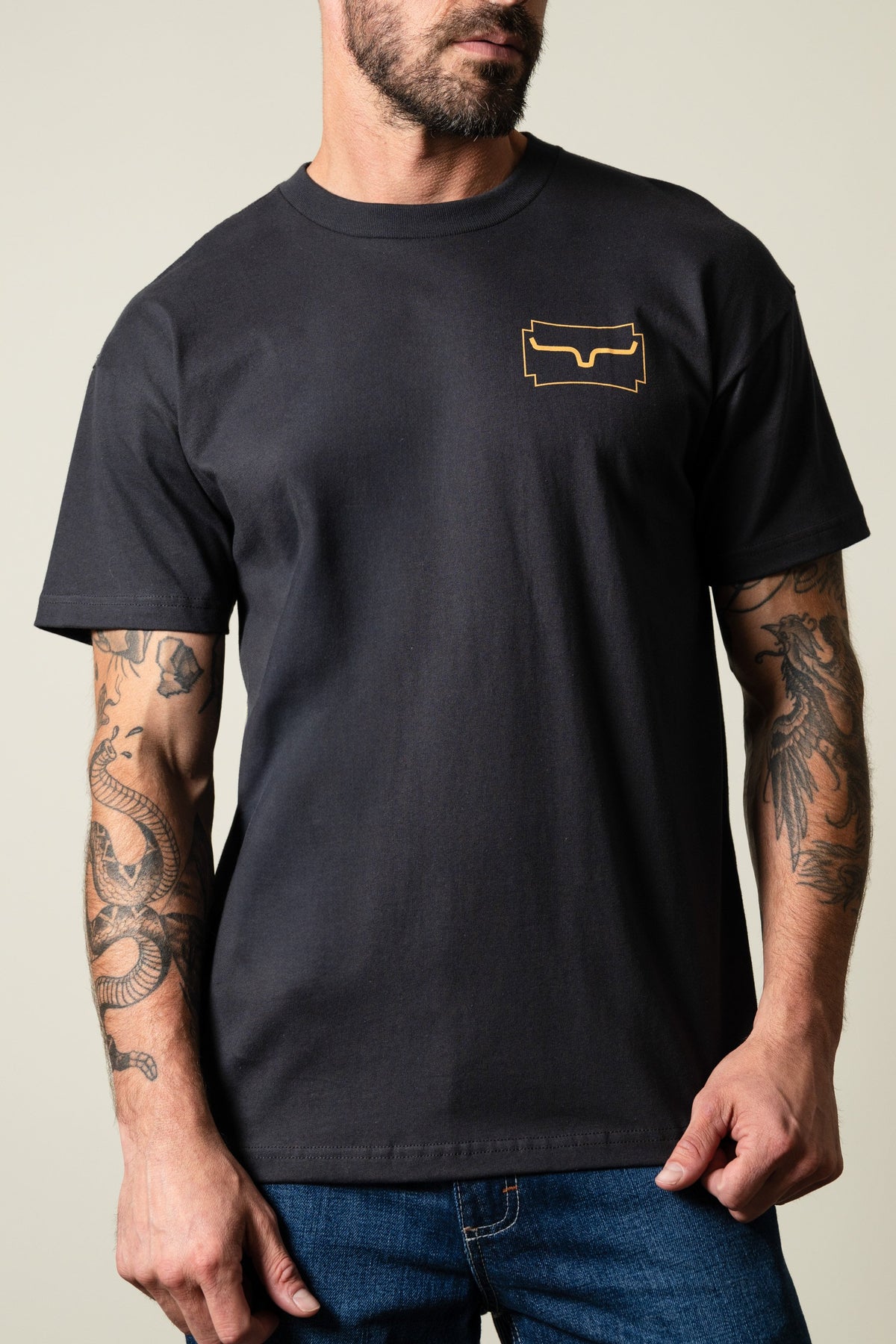 Kimes Ranch Camo Crest t-shirt in graphite black with a short-sleeve crew neck and a gold Kimes Ranch logo on the left chest; #color_graphite black