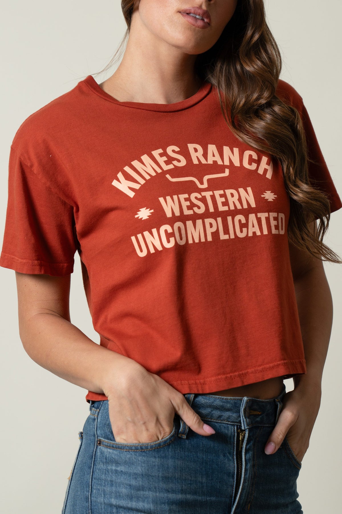 Kimes Ranch Cavell Burnt Red short sleeve tee featuring a vintage 'Kimes Ranch Western Uncomplicated' graphic print; #color_burnt red