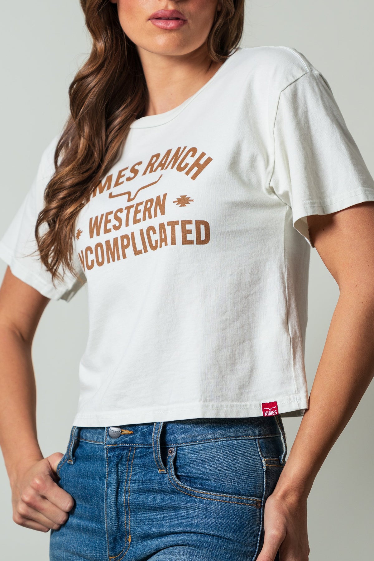 Kimes Ranch Cavell Natural shirt featuring a 'Western Uncomplicated' print with a Kimes Ranch logo at the center; #color_natural