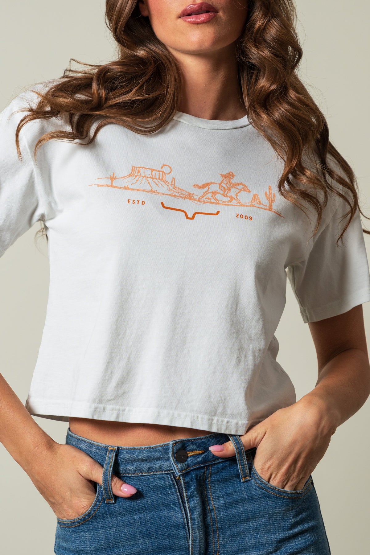 Kimes Ranch Go West short sleeve crop shirt in natural with orange western landscape graphic and ESTD 2009 text; #color_natural