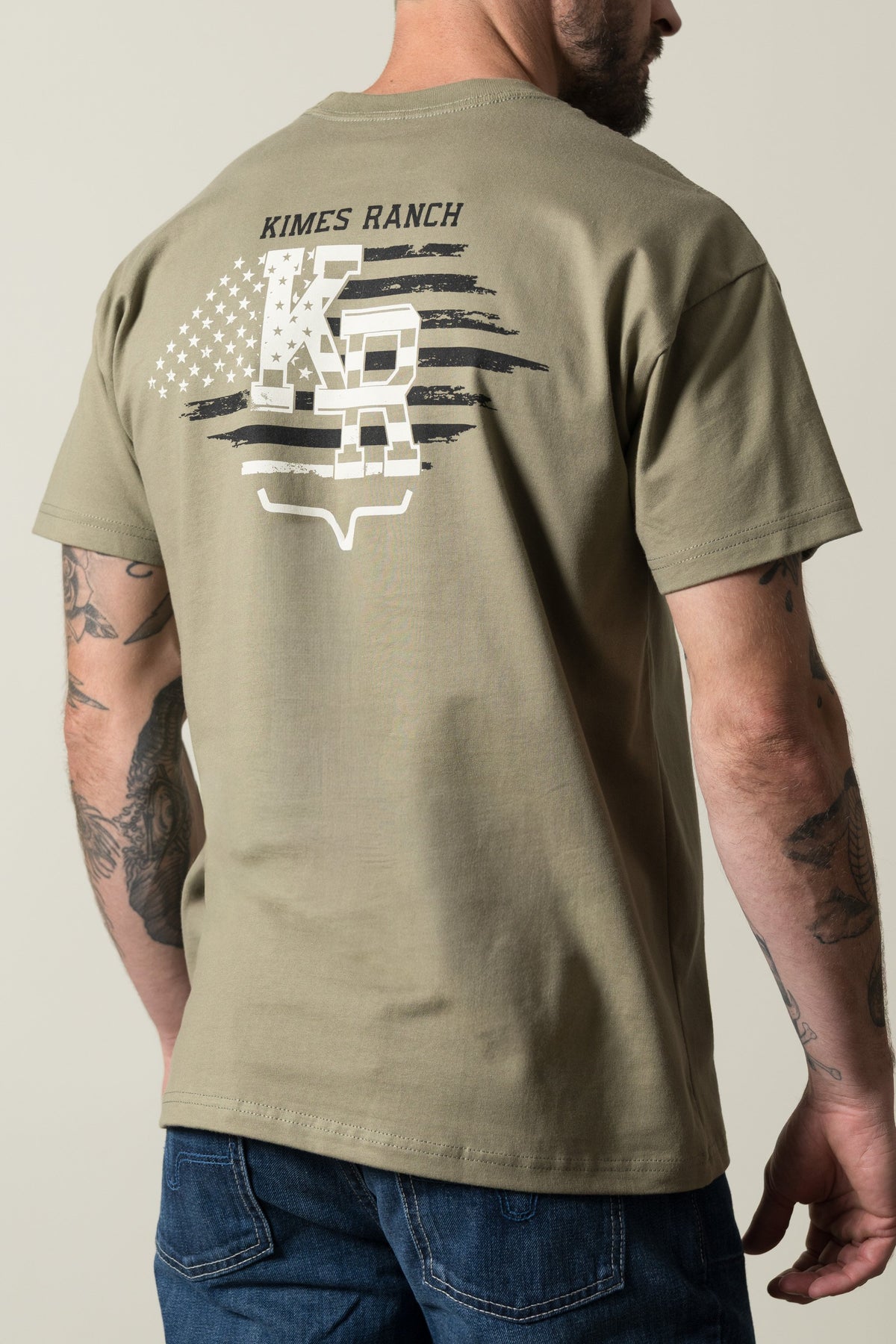 Kimes Ranch Red Glare short-sleeve shirt, Light Olive, featuring a back graphic with Kimes Ranch text, stars, and stripes; #color_light olive