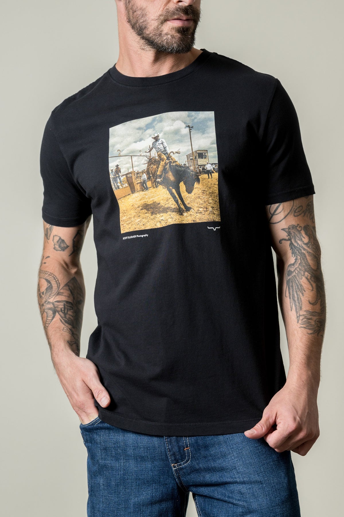 Kimes Ranch SS Classic Event black shirt with a photo print of a cowboy riding a bucking bronco; #color_black