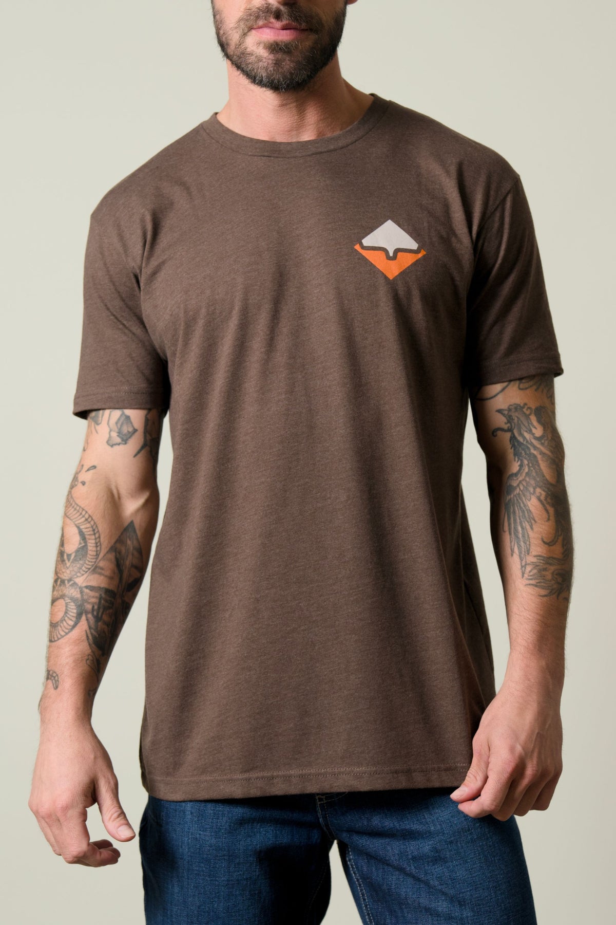 Kimes Ranch Warmth Shirt in brown with short sleeves and a chest graphic of a white and orange diamond